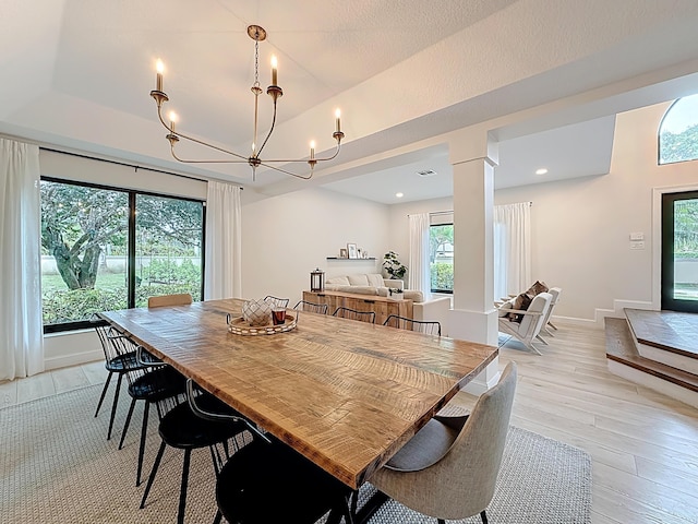 dining area with an inviting chandelier and light wood finished floors