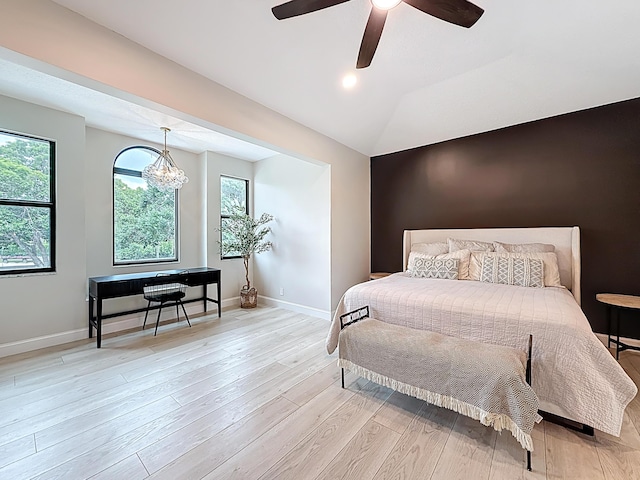 bedroom with light wood-type flooring, baseboards, and multiple windows