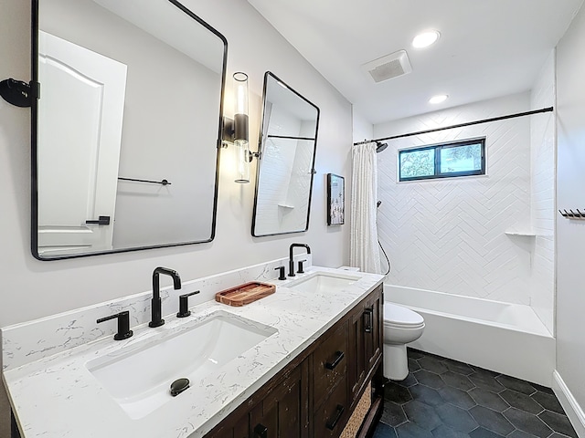 full bath featuring shower / bath combo with shower curtain, a sink, visible vents, and toilet