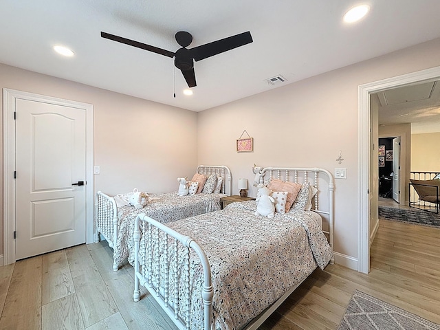 bedroom featuring attic access, recessed lighting, visible vents, and light wood finished floors