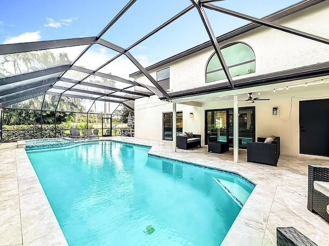 view of swimming pool with a pool with connected hot tub, a ceiling fan, an outdoor living space, and a patio area