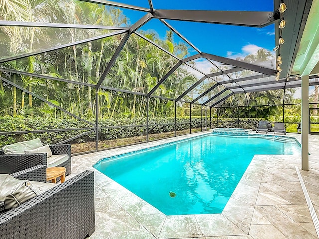 view of pool with a patio area, a lanai, and a pool with connected hot tub