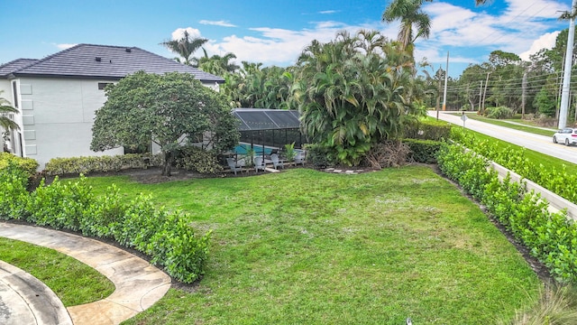 view of yard with glass enclosure