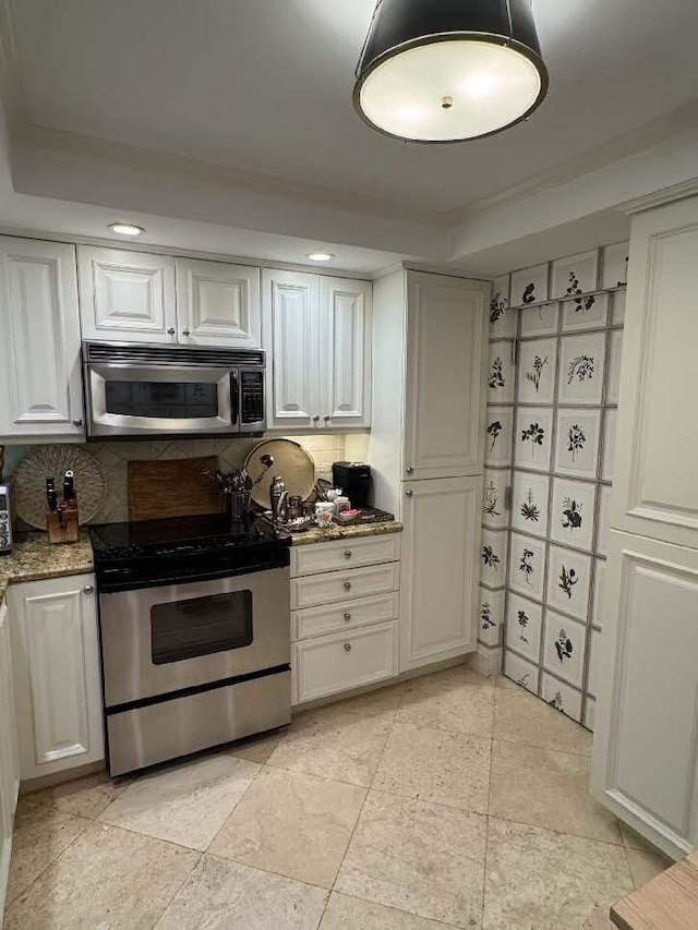 434 Chilean Ave Unit 2B, Palm Beach, FL 33480 - kitchen with appliances with stainless steel finishes, decorative backsplash, light stone counters, and white cabinetry