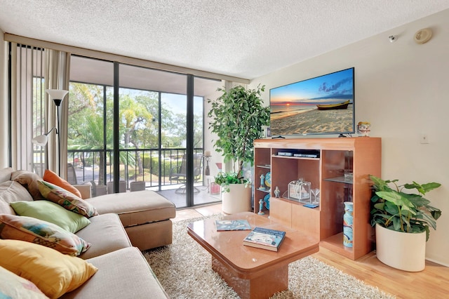 7847 Lakeside Blvd Unit 1023, Boca Raton, FL 33434 - living room featuring floor to ceiling windows, a textured ceiling, and wood finished floors