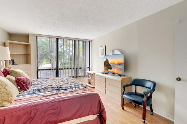 7847 Lakeside Blvd Unit 1023, Boca Raton, FL 33434 - bedroom featuring a textured ceiling, wood finished floors, and baseboards