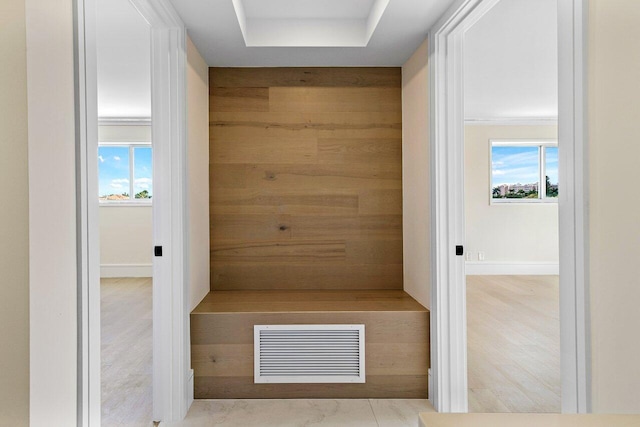 interior space with wood finished floors, visible vents, and a healthy amount of sunlight