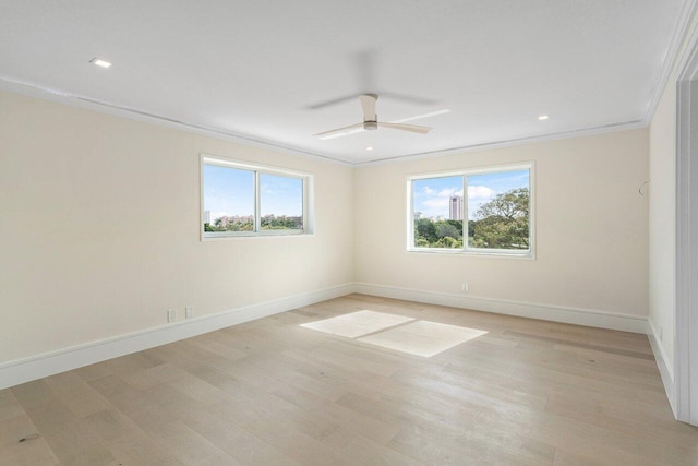 spare room with ceiling fan, ornamental molding, and a healthy amount of sunlight