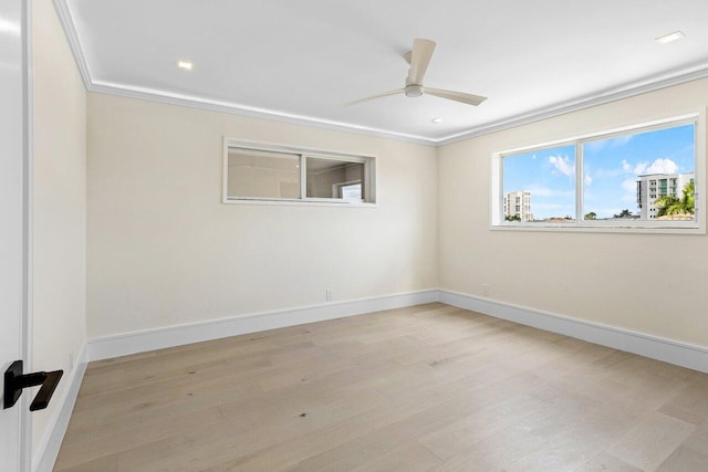 unfurnished room with a ceiling fan, baseboards, ornamental molding, and light wood finished floors