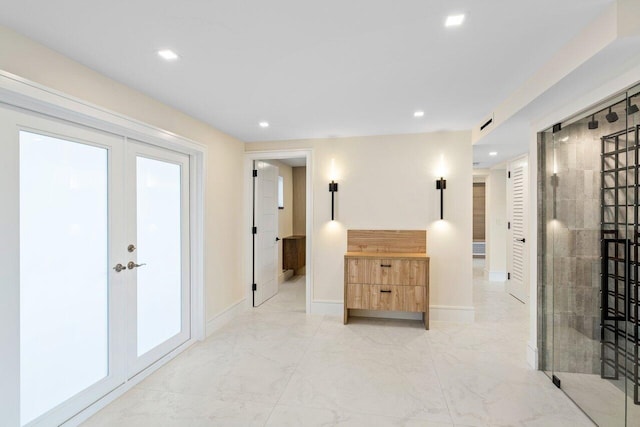 hallway with french doors, baseboards, recessed lighting, and marble finish floor