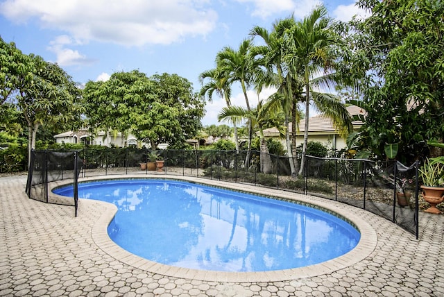 view of swimming pool featuring fence