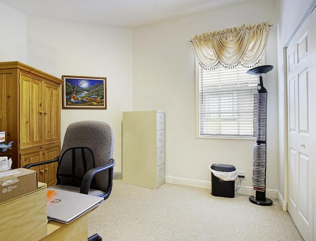 office space with light carpet and baseboards