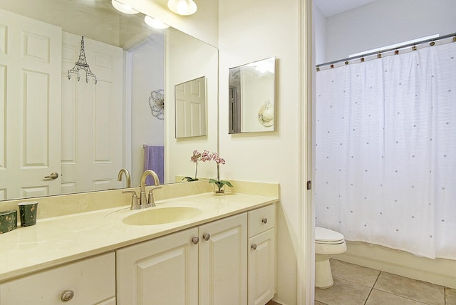 bathroom featuring tile patterned floors, toilet, vanity, and shower / bath combo with shower curtain