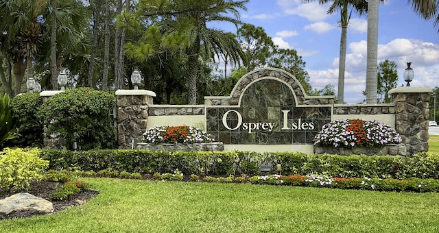 community / neighborhood sign featuring a lawn