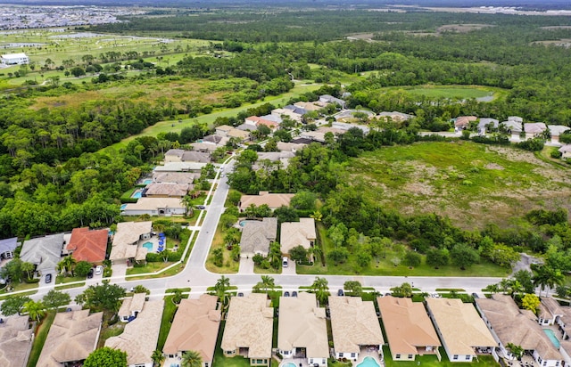 aerial perspective of suburban area featuring a heavily wooded area