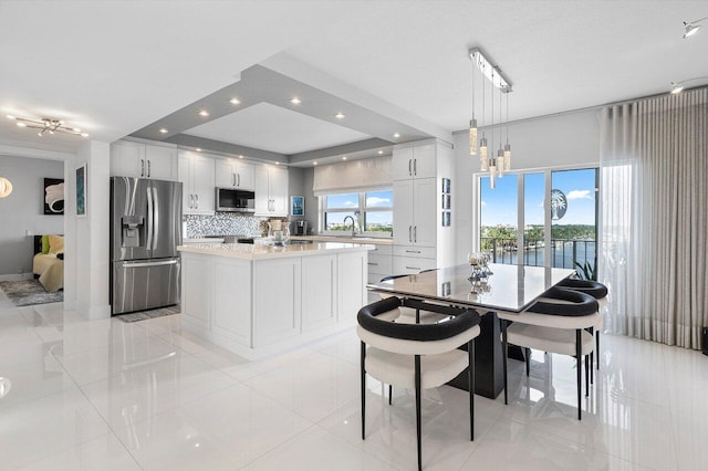 400 Seasage Dr Unit 804, Delray Beach, FL 33483 - dining space with light tile patterned flooring, a water view, and recessed lighting