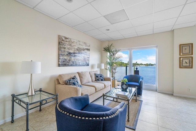 400 Seasage Dr Unit 804, Delray Beach, FL 33483 - living area with a water view, a drop ceiling, baseboards, and light tile patterned floors
