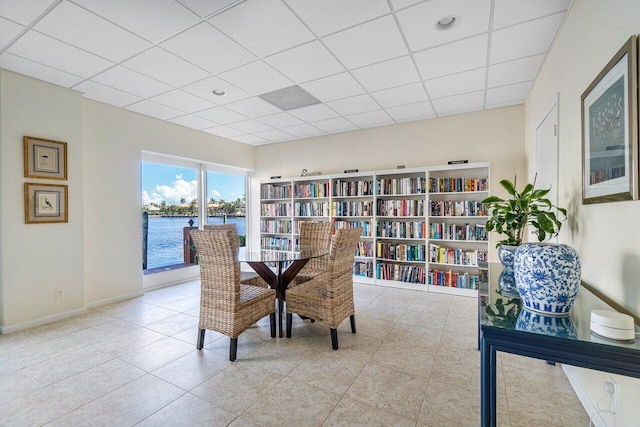 400 Seasage Dr Unit 804, Delray Beach, FL 33483 - dining area with tile patterned floors, baseboards, a water view, and a drop ceiling