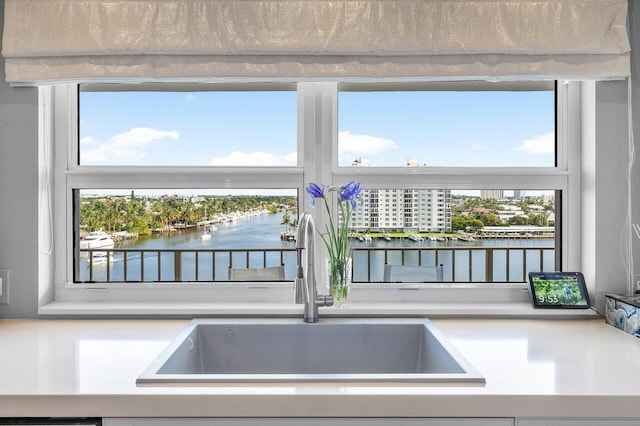 400 Seasage Dr Unit 804, Delray Beach, FL 33483 - interior details with light countertops, a sink, and a water view