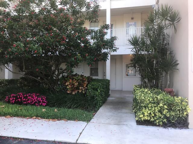 view of exterior entry featuring a balcony and stucco siding