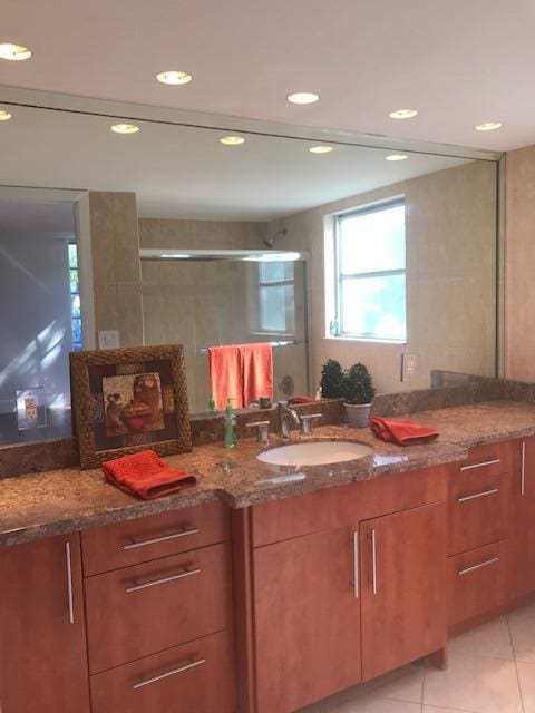 bathroom featuring recessed lighting, vanity, and tile patterned flooring