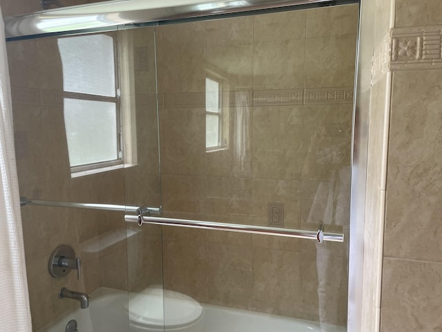 bathroom with shower / tub combo and toilet