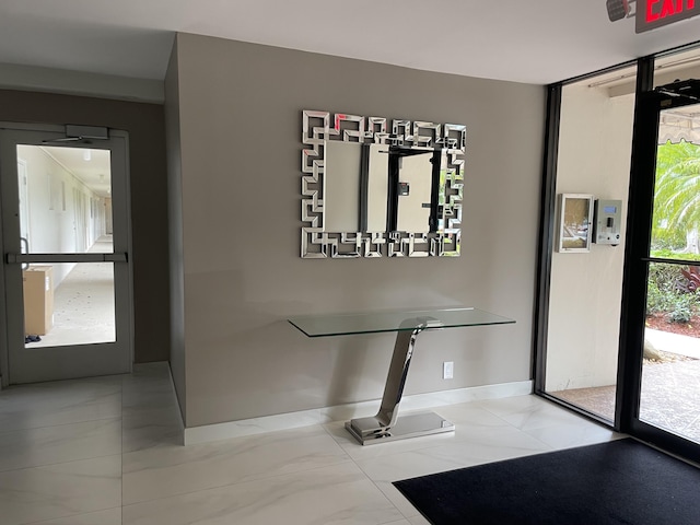 foyer featuring baseboards