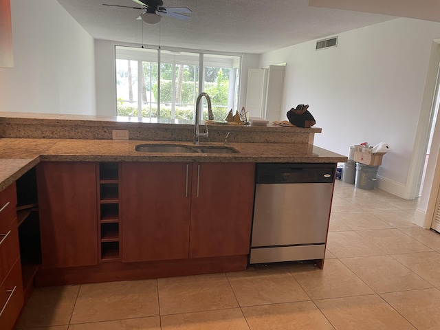 kitchen featuring visible vents, dishwasher, a sink, a ceiling fan, and stone counters
