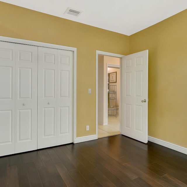 21504 Halstead Dr, Boca Raton, FL 33428 - unfurnished bedroom featuring baseboards, dark wood-style flooring, and a closet