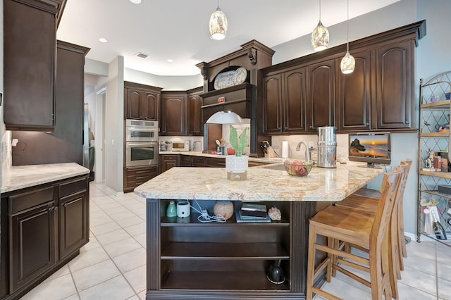 21504 Halstead Dr, Boca Raton, FL 33428 - kitchen featuring a center island, dark brown cabinets, open shelves, backsplash, and light stone counters
