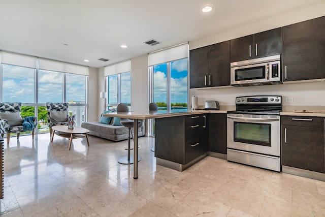 kitchen with visible vents, stainless steel appliances, a wealth of natural light, and light countertops
