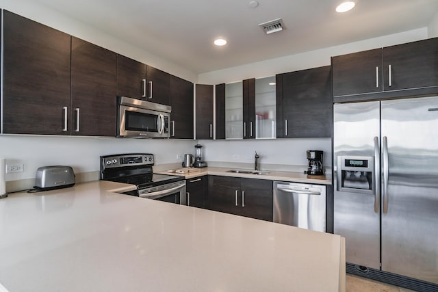 kitchen featuring recessed lighting, a sink, stainless steel appliances, visible vents, and light countertops