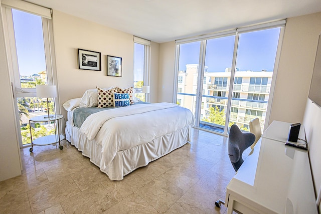 bedroom with multiple windows and floor to ceiling windows