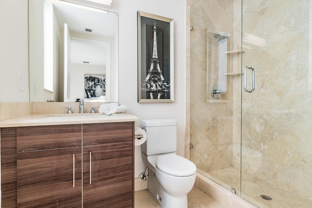 bathroom featuring tile patterned floors, toilet, vanity, visible vents, and a stall shower