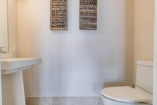 bathroom with toilet and a sink