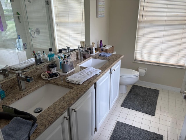 full bathroom featuring a shower stall, tile patterned flooring, a sink, and double vanity