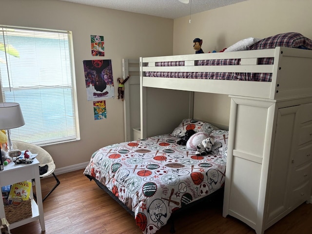 bedroom featuring baseboards and light wood-style flooring