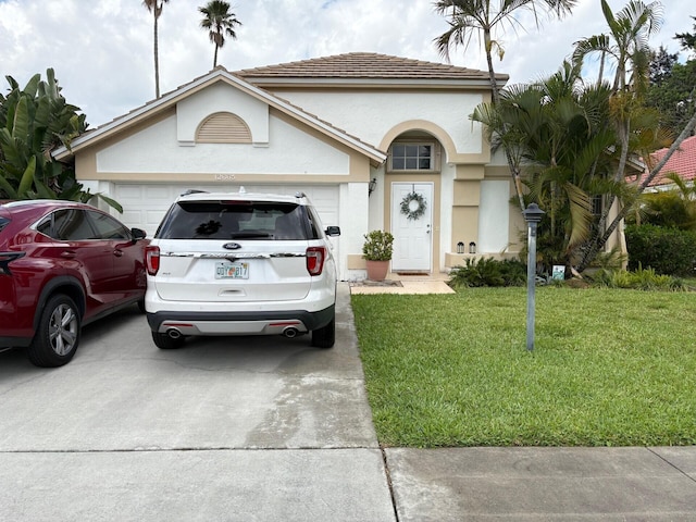 view of front of property with an attached garage, a front lawn, stucco siding, and concrete driveway
