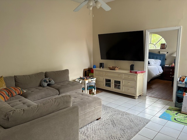 living area featuring ceiling fan and light tile patterned floors