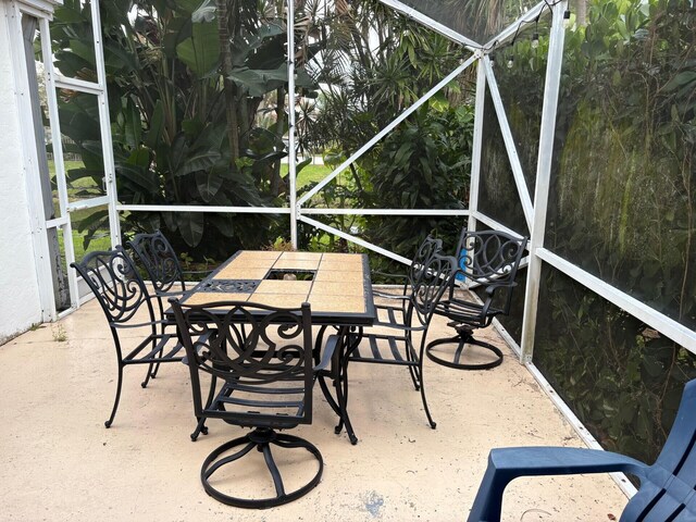 view of patio / terrace featuring a lanai and outdoor dining space