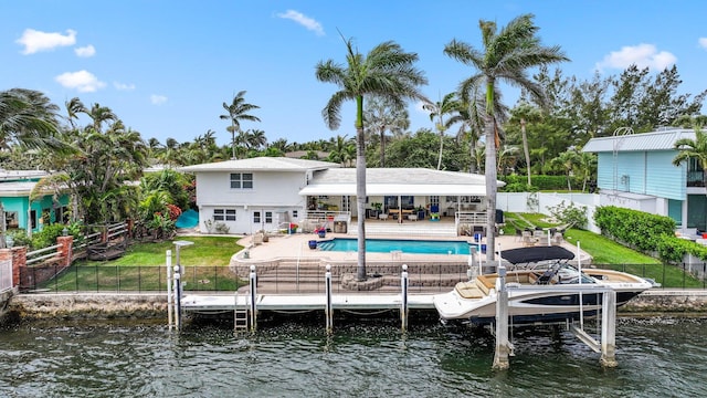442 SE 17th Ter, Deerfield Beach, FL 33441 - rear view of property with a fenced in pool, boat lift, a fenced backyard, a water view, and a lawn
