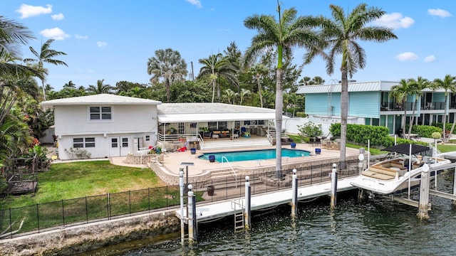 442 SE 17th Ter, Deerfield Beach, FL 33441 - rear view of house with a water view, a fenced backyard, stucco siding, and a lawn