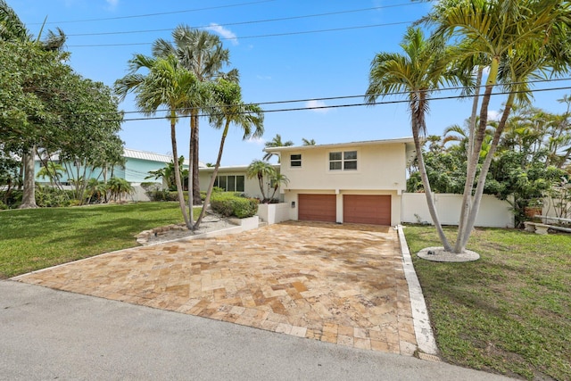 442 SE 17th Ter, Deerfield Beach, FL 33441 - view of front of home featuring stucco siding, driveway, a front yard, a garage, and fence