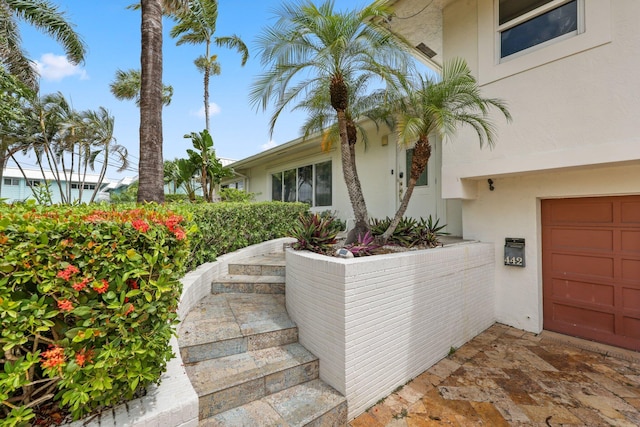 442 SE 17th Ter, Deerfield Beach, FL 33441 - entrance to property with a garage and stucco siding