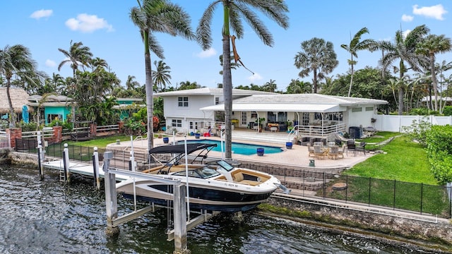 442 SE 17th Ter, Deerfield Beach, FL 33441 - rear view of property featuring a water view, a lawn, boat lift, a fenced backyard, and a fenced in pool