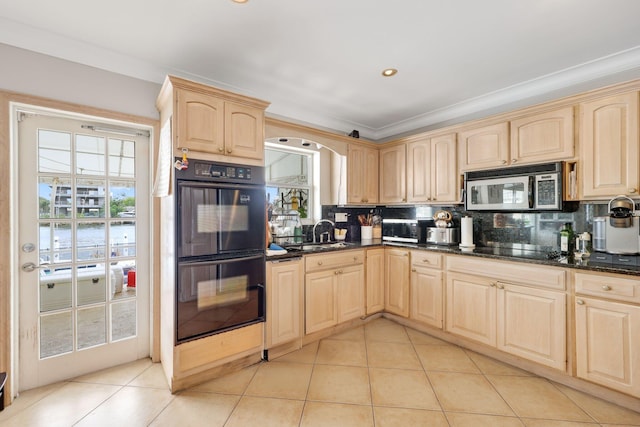 442 SE 17th Ter, Deerfield Beach, FL 33441 - kitchen with tasteful backsplash, light brown cabinetry, black appliances, light tile patterned flooring, and a sink