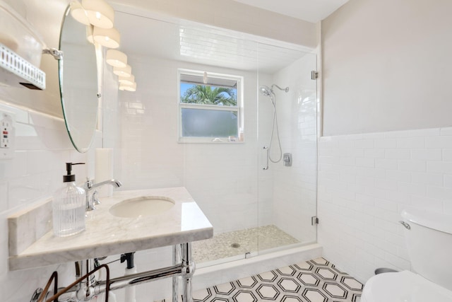 442 SE 17th Ter, Deerfield Beach, FL 33441 - full bath with a stall shower, toilet, a wainscoted wall, tile walls, and a sink