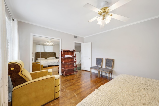 442 SE 17th Ter, Deerfield Beach, FL 33441 - bedroom with a closet, crown molding, visible vents, ceiling fan, and wood finished floors