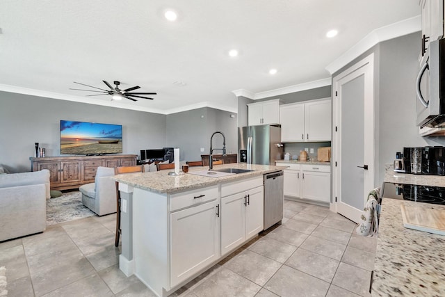 6449 NW Castlebrook Ave, Port Saint Lucie, FL 34983 - kitchen featuring crown molding, appliances with stainless steel finishes, a sink, a ceiling fan, and open floor plan