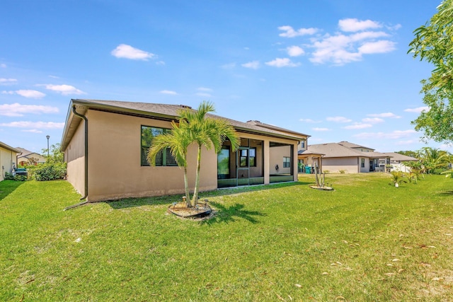 6449 NW Castlebrook Ave, Port Saint Lucie, FL 34983 - back of property with a sunroom, stucco siding, and a yard